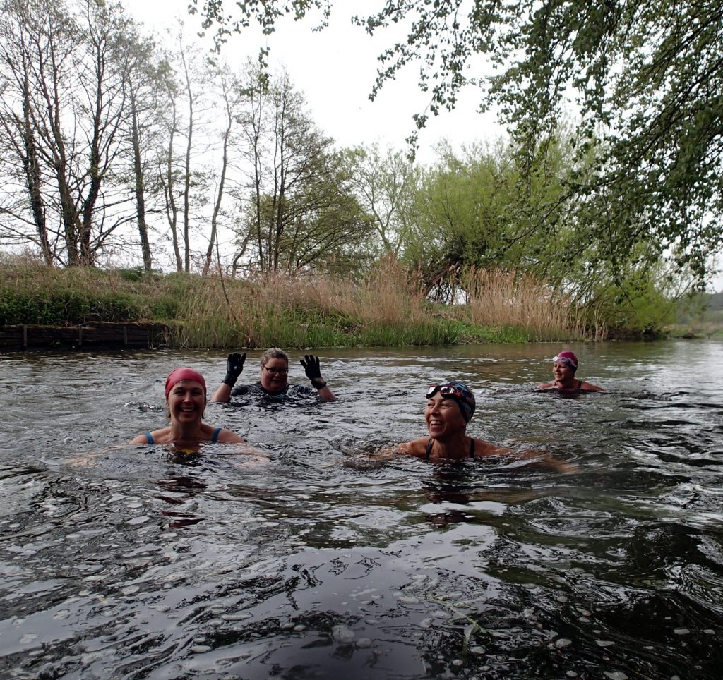 four swimmers in the water