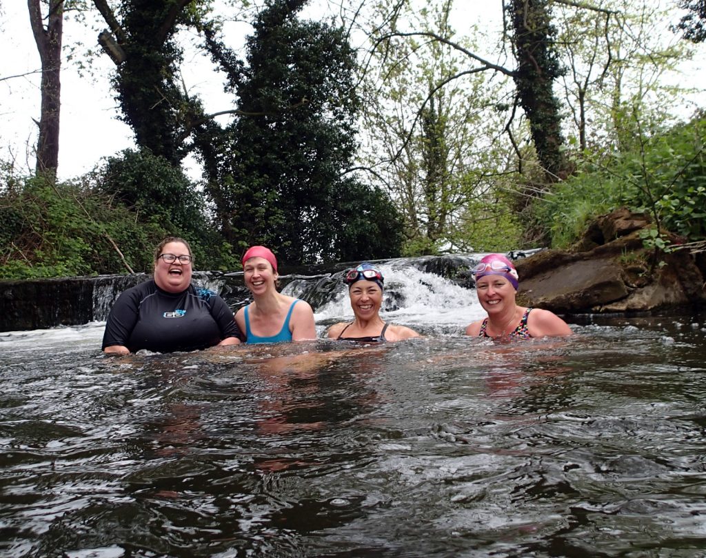 four swimmers in a weir