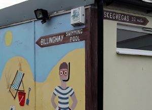 mural with swimmer and sign