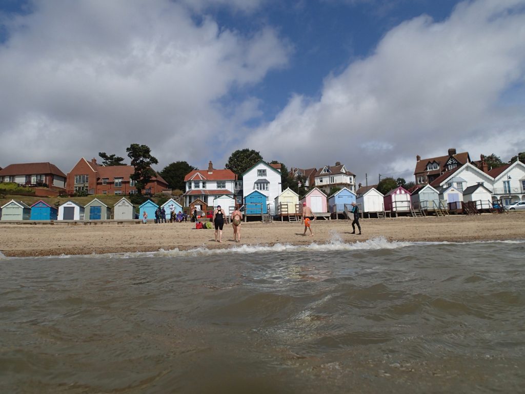 sea and beach huts and swimmers