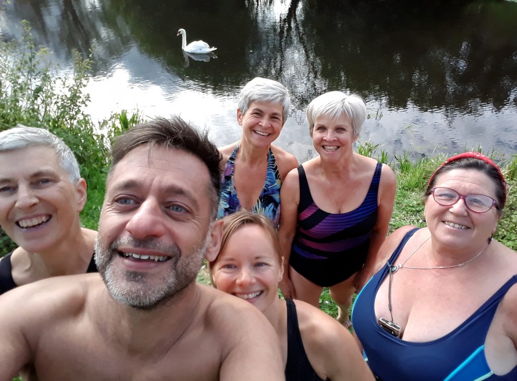 six swimmers selfie, swan and water