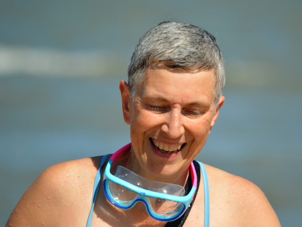 swimmer headshot with big goggles round her neck