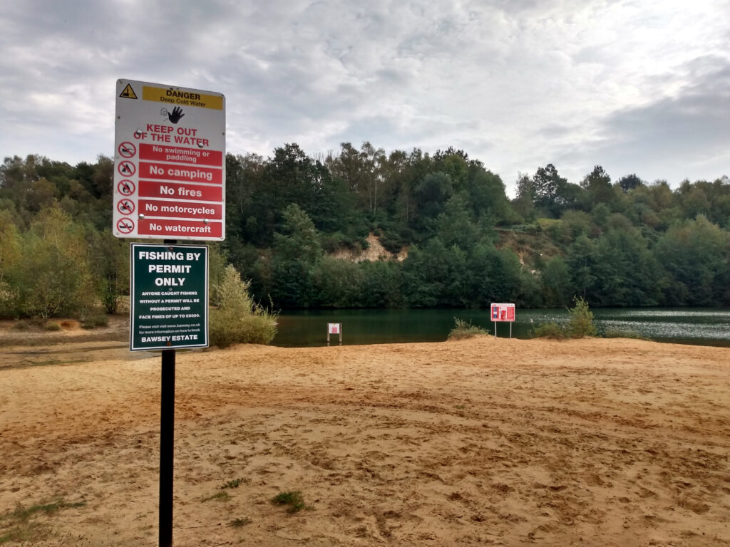 no swimming signage and lake