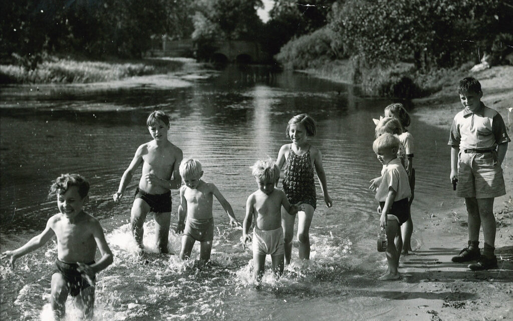 children playing in shallow water