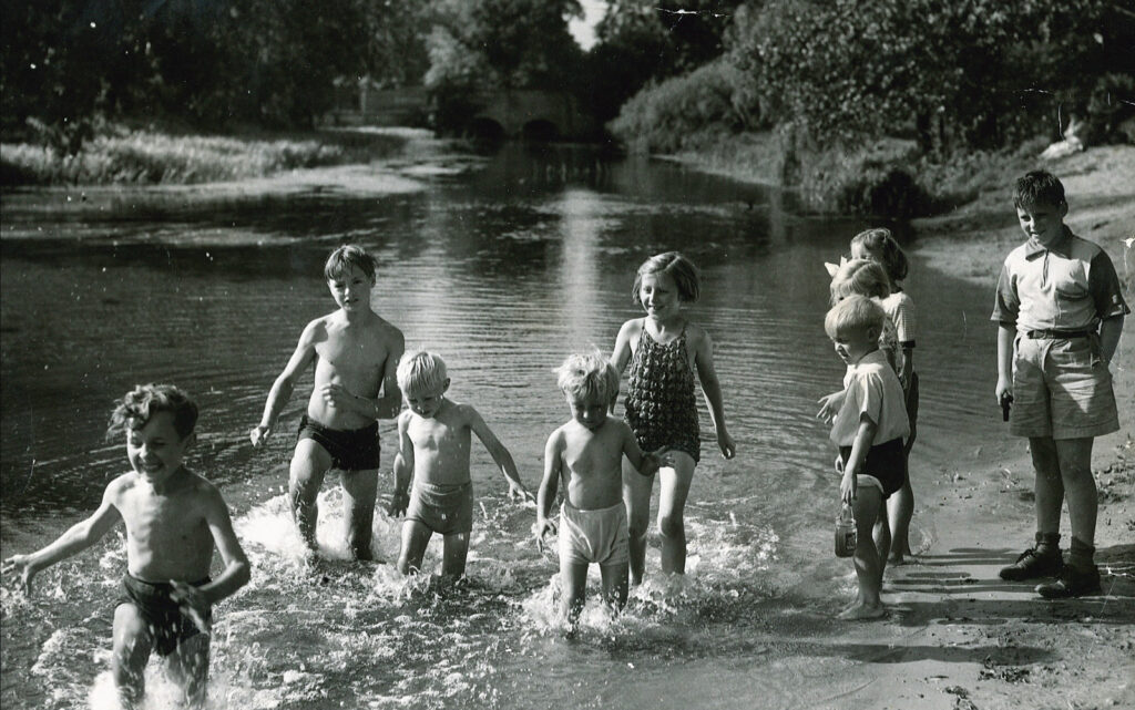children splashing in river