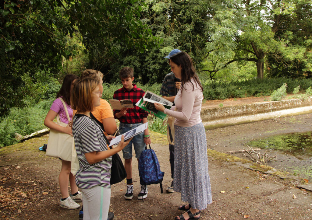 young people looking at books outdoors