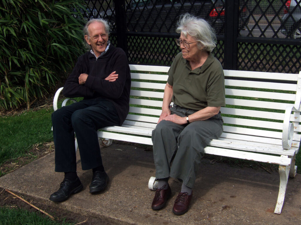 Dad and mum on a bench, laughing