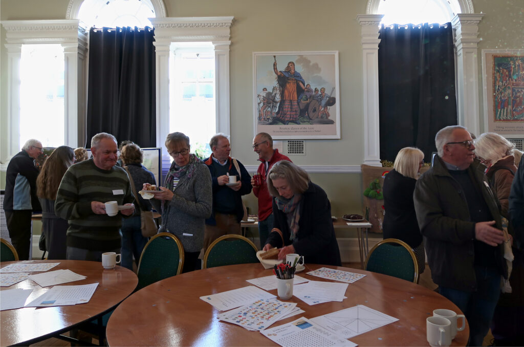 15 people chatting and looking at displays in Thetford Guildhall