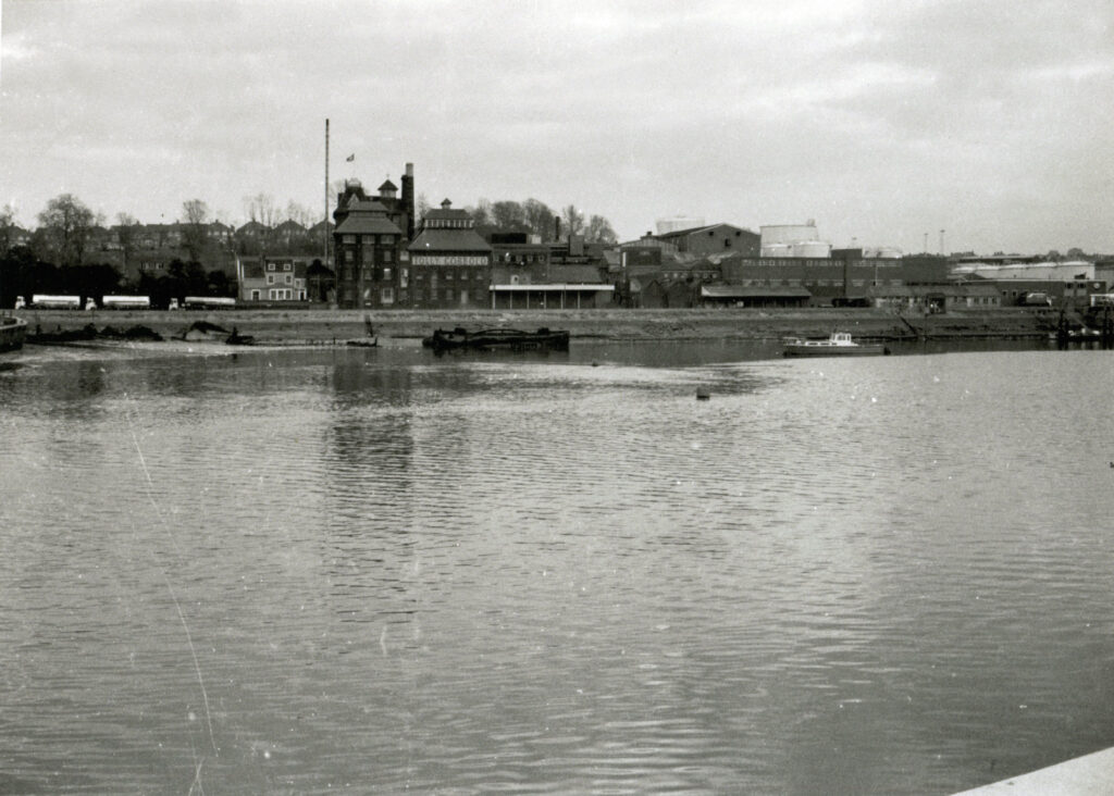 Looking across the docks to Tolly Cobbold and other buildings, black-and-white photo