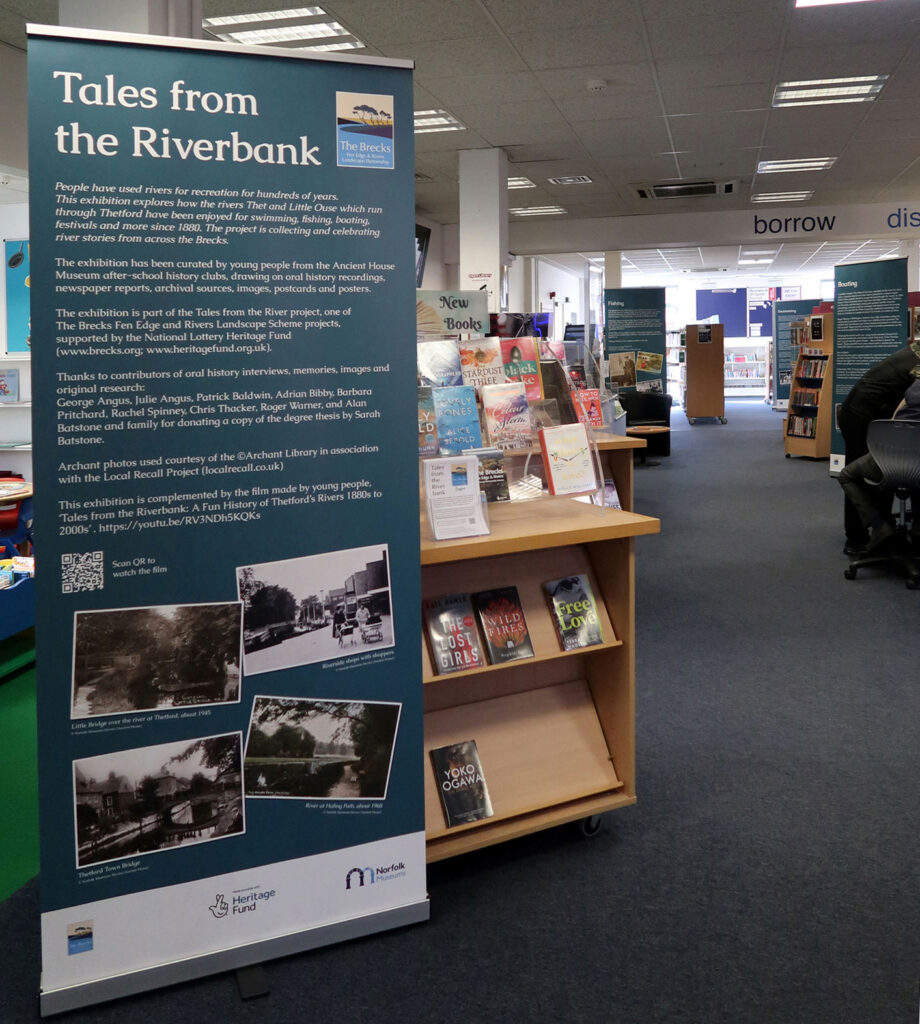 pop-up panel shown within the library, standing to either side of the route through from the front to the back of the library, with the introduction panel first, and others seen further back in the large bookshelf lined room