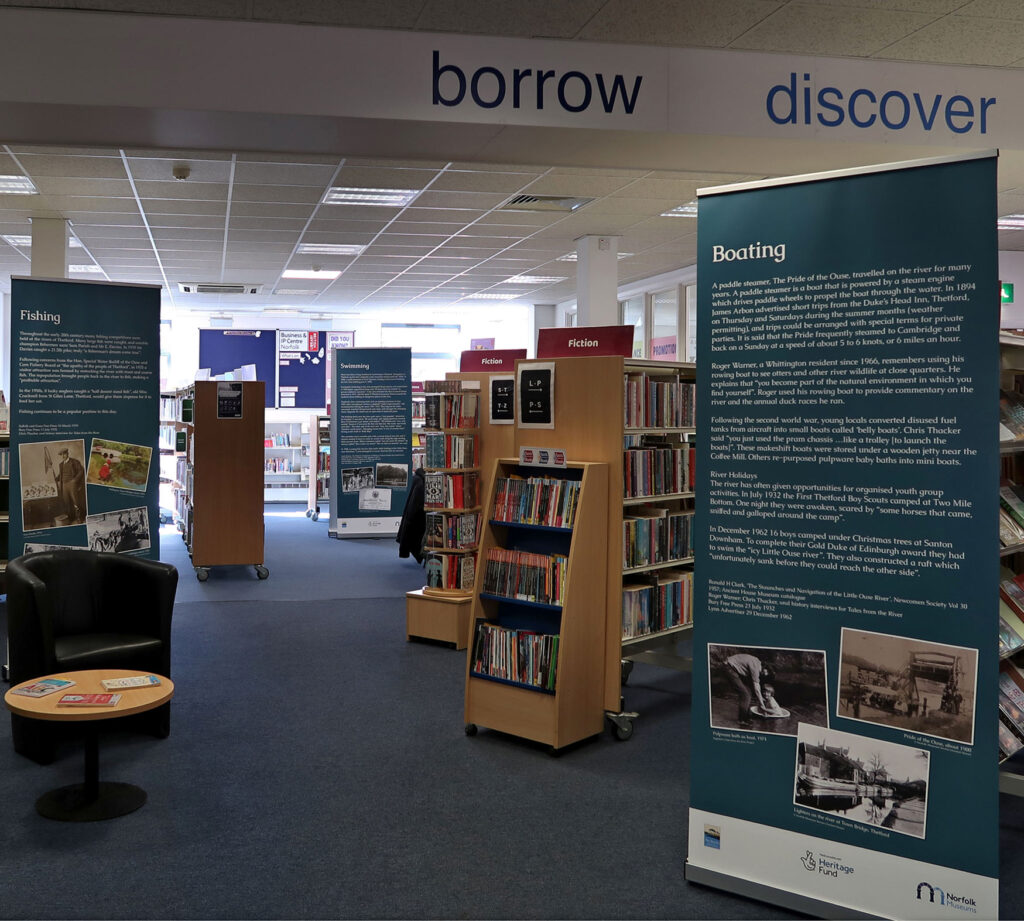 pop-up panel shown within the library, standing to either side of the route through from the front to the back of the library, with the boating panel on the right and others seen in the distance