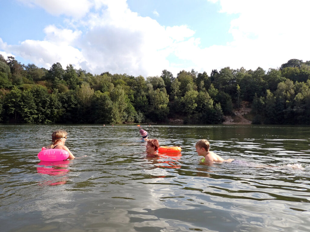 Swimmers in the lake, including a young boy