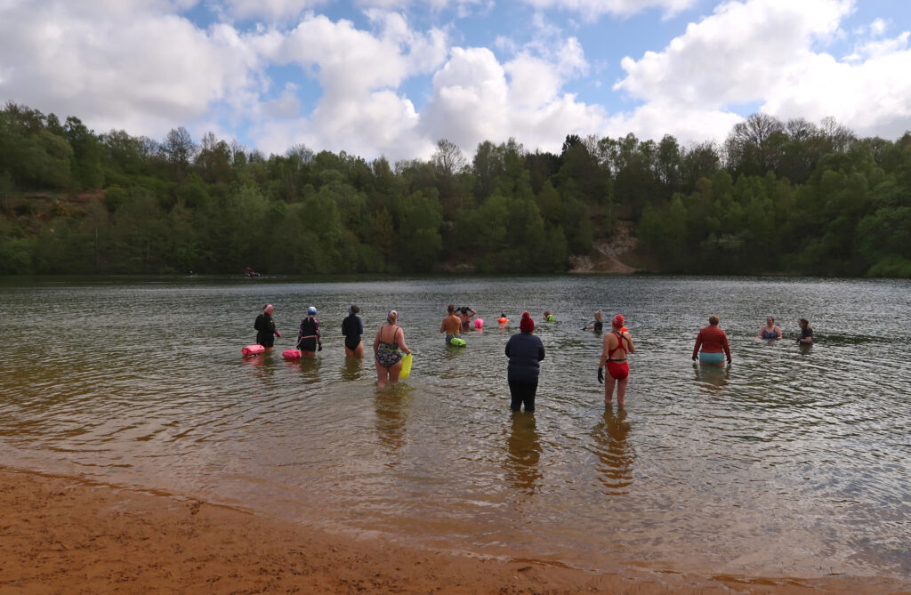 swimmers going into the water at Brickyard Lake, sandy beach