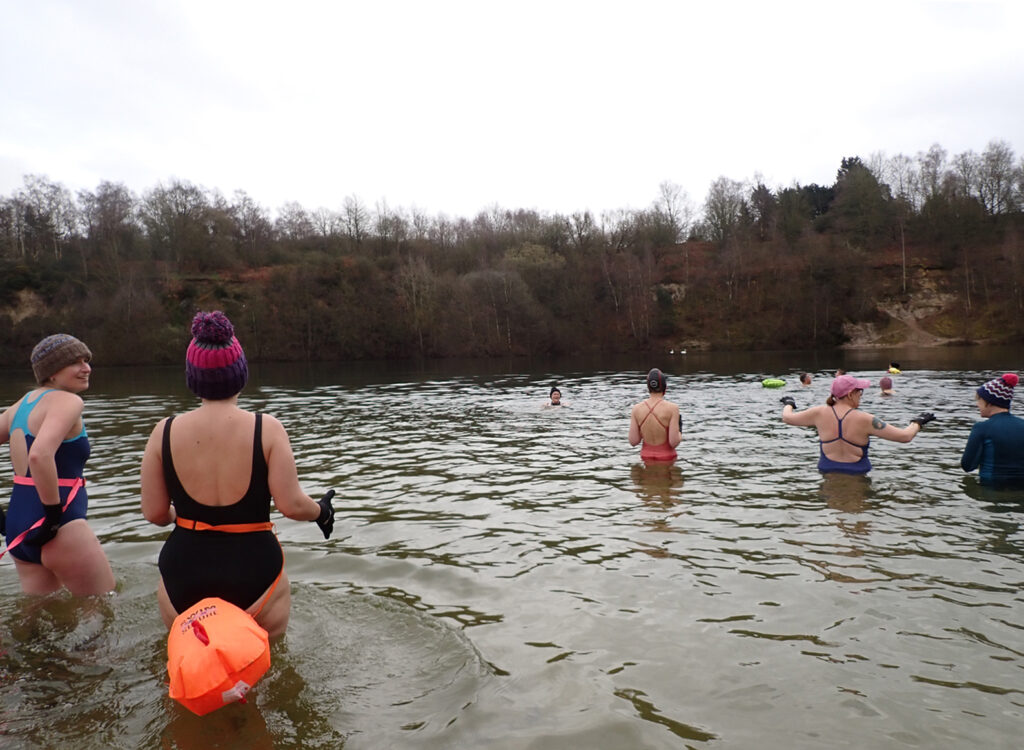 swimmers going into the water at Brickyard Lake, sandy beach